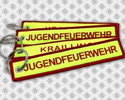 Gestickter Schlüsselanhänger mit Kettelrand Hintergrund neon Feuerwehr