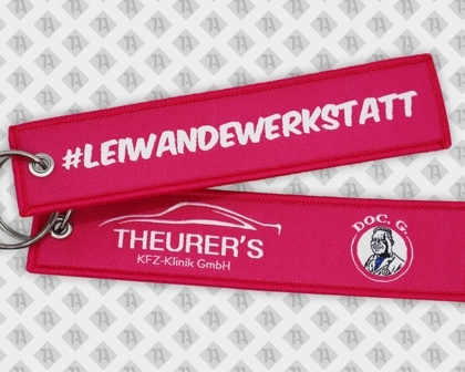 Pinker Werbeschlüsselanhänger mit Auto-Logo und Hashtag – KFZ-Werkstatt Keytag für Kunden und Fans von Theurer's