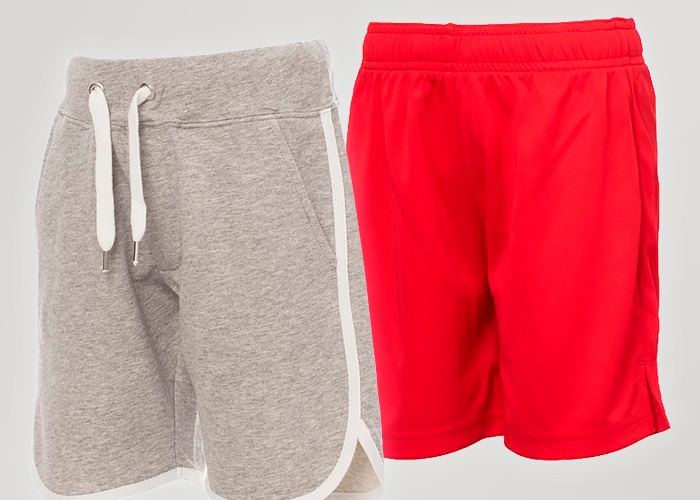 Zwei kurze Kinderhosen in Grau und Rot stehen vor hellem Hintergrund nebeneinander.