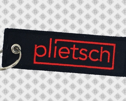 Schlüsselanhänger gestickt mit Kettelrand schwarz rot plietsch Ring und Öse Firmen