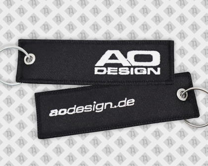 Schlüsselanhänger gestickt eckig mit mit Ringöse und Kettelrand schwarz ao design Firmen