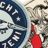 Nahaufnahme gewebter Patches mit Standard-Webgarn – detailreiche Designs mit präziser Webtechnik.