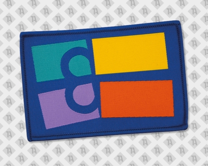 Rechteckiger Aufnäher mit vier bunten Farbflächen in Gelb, Orange, Grün und Lila, blauer Rand und stilisiertem Buchstaben „B“ im modernen Logodesign.