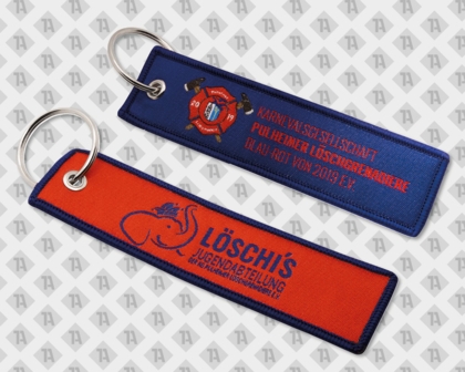 Roter Schlüsselanhänger mit blauem Rand, Elefantenlogo und Aufschrift „Löschi’s Jugendabteilung der KG Pulheimer Löschfreunde e.V.“