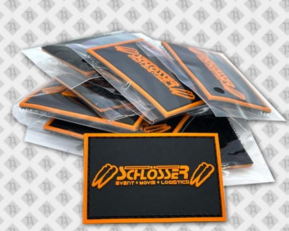 Rechteckiger Patch Aufnäher Rubber PVC Firma orange schwarz Event