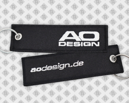Schlüsselanhänger gestickt eckig mit mit Ringöse und Kettelrand schwarz ao design Firmen
