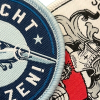 Nahaufnahme gewebter Patches mit Standard-Webgarn – detailreiche Designs mit präziser Webtechnik.